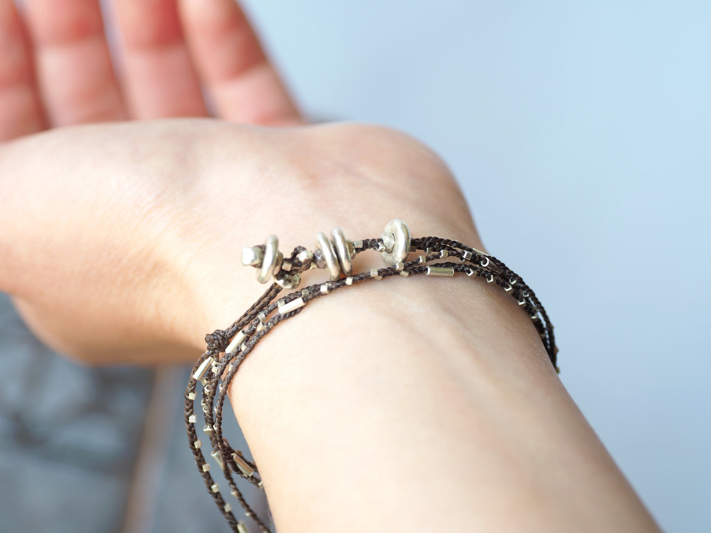 silver braided bracelet brown